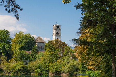 The Captain's Tower and Saint Anthony of Padua Church in central Bihac, Una-Sana Canton, Federation of Bosnia and Herzegovina. The River Una is in the foregroundの写真素材