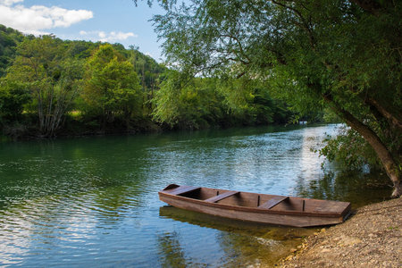 A wooden boat on the River Una north of Martin Brod, Bihac, in the Una National Park. Una-Sana Canton, Federation of Bosnia and Herzegovina. Early Septemberの写真素材