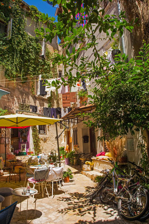 Rovinj, Croatia - July 7th 2023. A small bar in a quiet back street of the historic centre of Rovinj old town in Istria, Croatiaのeditorial素材