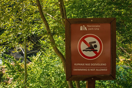 Bihac, Bosnia - September 8th 2023. A sign warns visitors to the Una National Park that swimming is not allowed in the area. Una-Sana Canton, Federation of Bosnia and Herzegovinaのeditorial素材