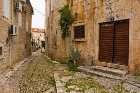 Supetar, Croatia - May 13th 2023. A street in Supetar on Brac Island, Croatia, with traditional kogule or kogulavanje paving. Common in coastal villages throughout Dalmatia, it uses pebbles from beachesのeditorial素材