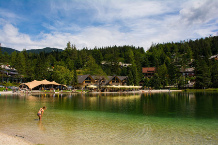 Kranjska Gora, Slovenia - August 21st 2022. A child plays in Jasna Lake near Kranjska Gora in the Upper Carniola region of north west Slovenia. An artificial lake created for tourism purposesのeditorial素材