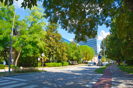 Erjavceva Ulica in downtown Nova Gorica, Slovenia. One of the principle streets in this planned city, it runs from the heart of the city to Trg Evrope or Europe Square which symbolically connects the city with its Italian neighbor, Gorizia. EDA Center centre backgroundの写真素材