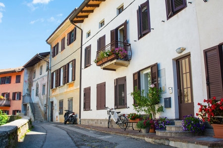 A charming row of quaint historic houses in Solkan near Nova Gorica, Primorska, Slovenia. Adorned with vibrant summer flowersの写真素材