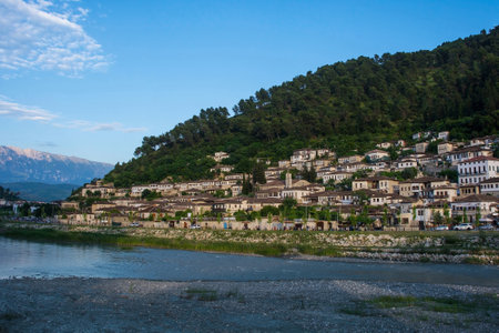 The historic Gorica quarter of Berat in Albania. Berat is UNESCO listed and is known as City of a Thousand Windows. It is famous for its traditional Ottoman architecture. Mali Partizan Mountain is background right, and the Osum River in the foregroundの写真素材