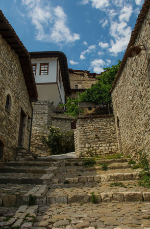 A cobbled stepped street in the historic Mangalem quarter of Berat in Albania. Berat is a UNESCO World Heritage Site and is known as City of a Thousand Windows. It is famous for its traditional Ottoman architectureの写真素材
