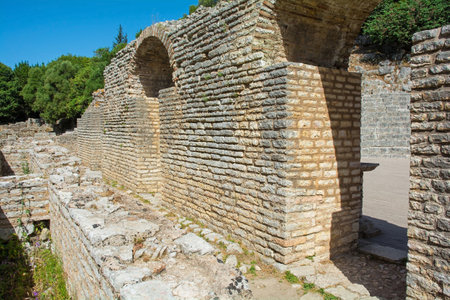 The arched entrance to the 3rd century Roman Amphitheatre in Butrint Archaeological Park, within Butrint National Park, southern Albania. A UNESCO World Heritage Site. One of the best-preserved monuments in Butrint. It could accommodate over 2,000 spectators and hosted dramatic performances, assemblies and gladiatorial gamesの写真素材