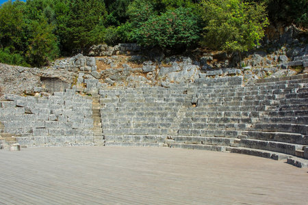 The Cavea seating area of the 3rd century Roman Amphitheatre in Butrint Archaeological Park, within Butrint National Park, southern Albania. A UNESCO World Heritage Site. One of the best-preserved monuments in Butrint. It could accommodate over 2,000 spectators and hosted dramatic performances, assemblies and gladiatorial gamesの写真素材