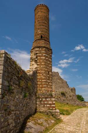 The minaret of the 14th century Red Mosque ruins within the fortified Berat Castle, southern Albania. The castle is a blend of Byzantine, Ottoman and medieval Albanian architectural influences, it is located on Kalaja Hill overlooking Berat and the Osum River.の写真素材