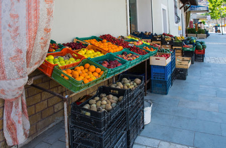 Street stalls selling fresh fruit and vegetables in the Mangalem district of Berat in southern Albania. Including cherries, peaches, apples, plums, potatoes, cucumbers, melons, peas, peppers and oranges. Berat is a major tourist centre, being UNESCO listed and famous for its Ottoman architectureの写真素材