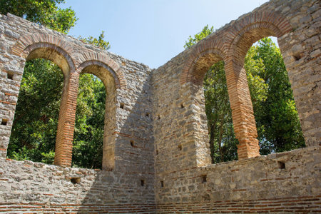 Windows in the early 6th century Byzantine Great Basilica in Butrint Archaeological Park, within Butrint National Park, southern Albania. A UNESCO World Heritage Site. Characterised by a central nave with side aisles separated by colonnades, a tripartite transept and a pentagonal apse which was hemispherical on its interior faceの写真素材