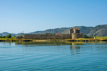 The Triangular Fortress in Butrint National Park, southern Albania. A UNESCO World Heritage Site. Also called Kalaja Trekendore, it was built by the Venetians in the 15th century to guard the Vivari Channel with a triangular design optimized to defend against naval attacks. It integrates elements of earlier Byzantine fortificationsの写真素材