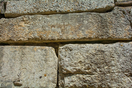 A wall with Hellenic inscriptions in Butrint Archaeological Park, within Butrint National Park, southern Albania. A UNESCO World Heritage Site. Known as the Tower of Inscriptions and dating back to 1st or 2nd century BC, it was originally part of a defensive tower. The Greek inscriptions relate to decrees issued by the highest authoritiesの写真素材
