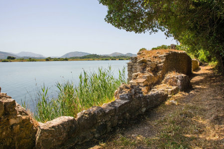 A lakeside path in Butrint Archaeological Park, within Butrint National Park, southern Albania. A UNESCO World Heritage Site. Part of the lakeside route, the walls form part of the cityâs ancient defensive fortificationsの写真素材