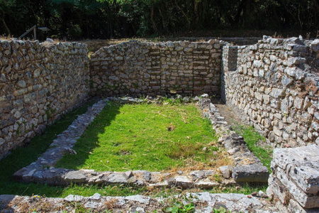 A Roman public bathhouse in Butrint Archaeological Park, within Butrint National Park, southern Albania. A UNESCO World Heritage Site. Located next to Roman Forum, it features a series of rooms for hot, warm and cold bathing (caldarium, tepidarium, frigidarium) with a hypocaust heating system. The baths served as a social and recreational hubの写真素材