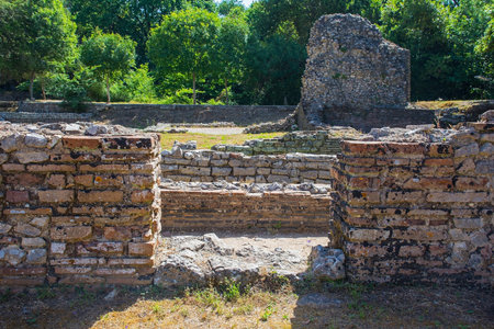 A Roman public bathhouse in Butrint Archaeological Park, within Butrint National Park, southern Albania. A UNESCO World Heritage Site. Located next to Roman Forum, it features a series of rooms for hot, warm and cold bathing (caldarium, tepidarium, frigidarium) with a hypocaust heating system. The baths served as a social and recreational hubの写真素材