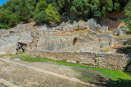 The Roman Forum in Butrint Archaeological Park, within Butrint National Park, southern Albania. A UNESCO World Heritage Site. This was Butrint's civic centre, surrounded by administrative and commercial buildings, and including a marketplace, temples and a basilica. The Abaton, also known as the Portico or Stoa, is seen background right - a long rectangular structure predating the amphitheatre. The Peristyle building rightの写真素材
