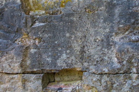 A wall with Hellenic inscriptions in Butrint Archaeological Park, within Butrint National Park, southern Albania. A UNESCO World Heritage Site. Known as the Tower of Inscriptions and dating back to 1st or 2nd century BC, it was originally part of a defensive tower. The Greek inscriptions relate to decrees issued by the highest authoritiesの写真素材