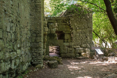 The Lion Gate in Butrint Archaeological Park, within Butrint National Park, southern Albania. An iconic feature of Butrint's fortifications, a Hellenistic-era entrance adorned with a lintel relief of a lion and a bullの写真素材