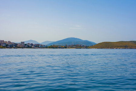 Sarande on the Ionian coastline of southern Albania, part of the Albanian Riviera. Here, the hills of the Ceraunian mountain range meet the Straits of Corfu in the eastern Mediterranean Seaの写真素材