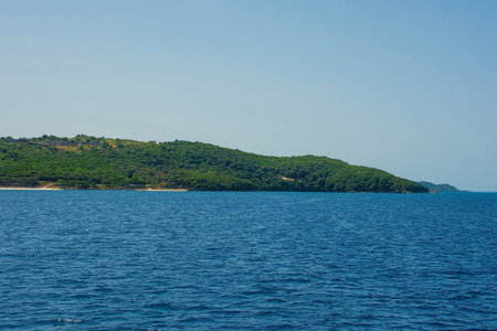 The Ionian coastline near Ksamil, part of the Albanian Riviera. Here, the green hills of the Ceraunian mountain range meet the Straits of Corfu in the eastern Mediterranean Seaの写真素材