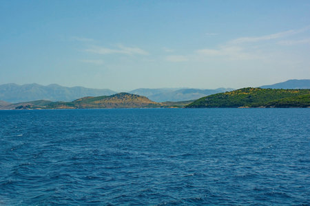 The Ionian coastline near Ksamil, part of the Albanian Riviera. Here, the green hills of the Ceraunian mountain range meet the Straits of Corfu in the eastern Mediterranean Seaの写真素材