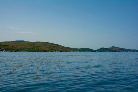 The Ionian coastline south of Sarande, part of the Albanian Riviera. Here, the green hills of the Ceraunian mountain range meet the Straits of Corfu in the eastern Mediterranean Seaの写真素材