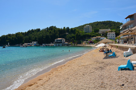 Early summer at Spile Beach at the northern end of Himare Bay on the coast of south Albania, part of the Albanian Riviera. Early June. Located in Vlore County, Himare lies between the Ceraunian Mountains and the Ionian Sea and is a major tourism centreの写真素材