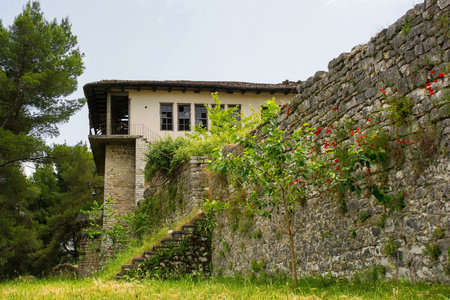 An abandoned Ottoman house in the Castle or Kalaja quarter of Berat, southern Albania. Berat is UNESCO listed and is known as City of a Thousand Windows. The once beautiful house now has broken windows, a collapsing roof, and overgrown vegetationの写真素材