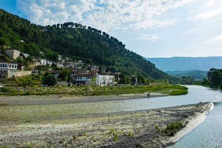 The historic Gorica quarter of Berat in Albania. Berat is UNESCO listed and is known as City of a Thousand Windows. It is famous for its traditional Ottoman architecture. Mali Partizan Mountain is background left, and the Osum River in the foregroundの写真素材