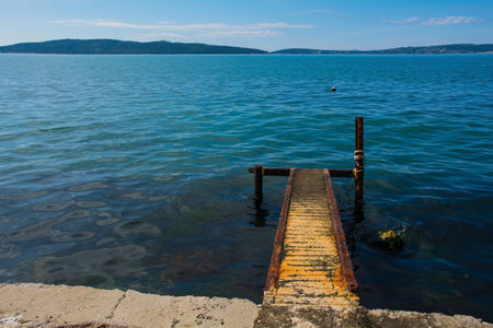 A rusted old landing stage on the Adriatic coast of Croatia at Kastel Kambelovac in Kastela. Late springの写真素材