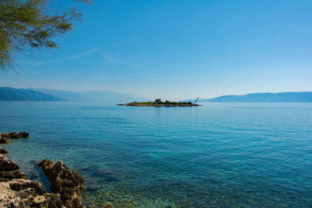 The island off the Adriatic coast of Novi Vinodolski, Primorje-Gorski Kotar County, Croatia. Mid-September. The historic Sv Martina chapel is the only building on this small islandの写真素材