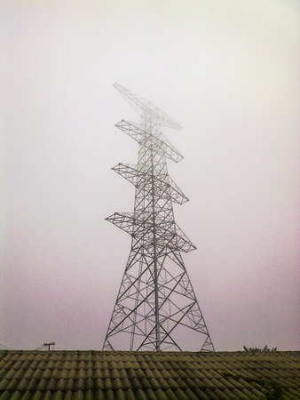 High voltage electricity pylon in the morning mist, Hongsa, Xaignabouli, Laos.