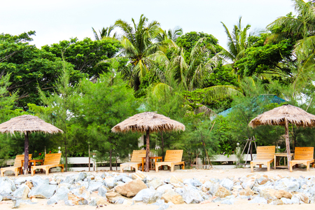 Umbrella and lounges at the shore of Thailand Ocean,Pran Buri,Prachuap Khiri Khan,Thailand.の写真素材