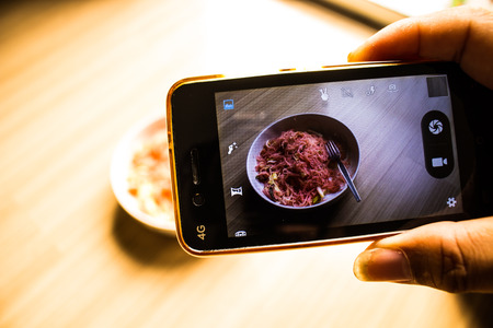 Hand phone photograph fried noodle by smartphone.の写真素材