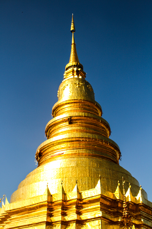 Golden pagoda for blue sky background. (Wat pratadhariphunchai,Lamphun, Thailand)の写真素材