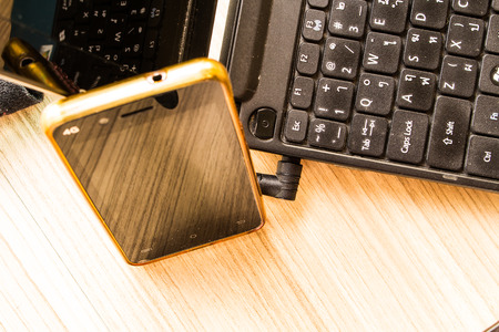 Phone Black and notebook on the floor at home.の写真素材