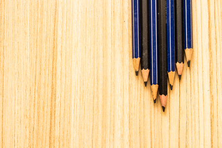 Pencil right side on a wooden brown floor background for top view.の写真素材