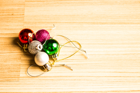 Color balls christmas left side on a wooden brown floor background.の写真素材