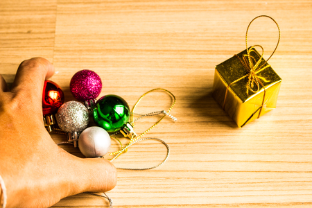 Handle color balls and gift box christmas on a wooden brown floor background.の写真素材