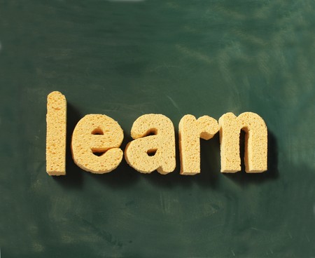 the word learn on a blackboard backgroundの写真素材