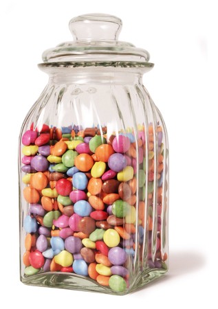 traditional sweet jar full of smarties on a white backgroundの写真素材