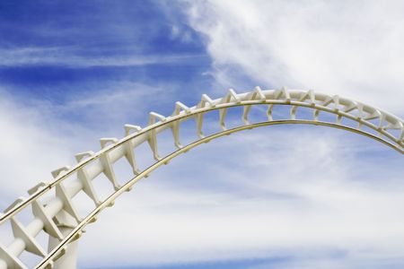 Empty roller coaster tracks against blue skyの写真素材
