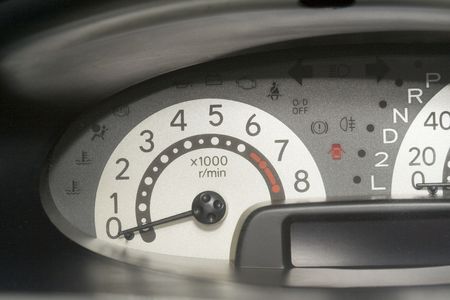 Car dashboard showing the speedometer with the needle pointing at zero