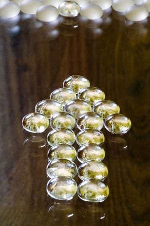 Arrow sign formed by some glass pebblesの写真素材