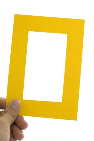 Hand holding a yellow frame isolated on white background