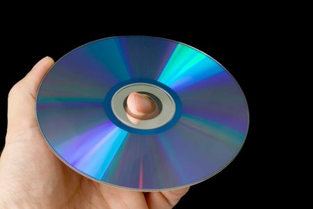 Hand holding a CD isolated on black background