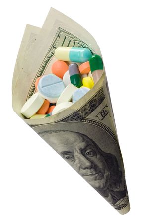 Pills wrapped by US money isolated on white background