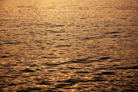 Calm sea surface during sunsetの写真素材