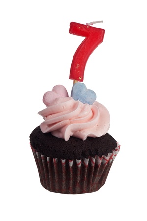 Mini cupcake with number seven candle for seven year anniversary isolated on white backgroundの写真素材